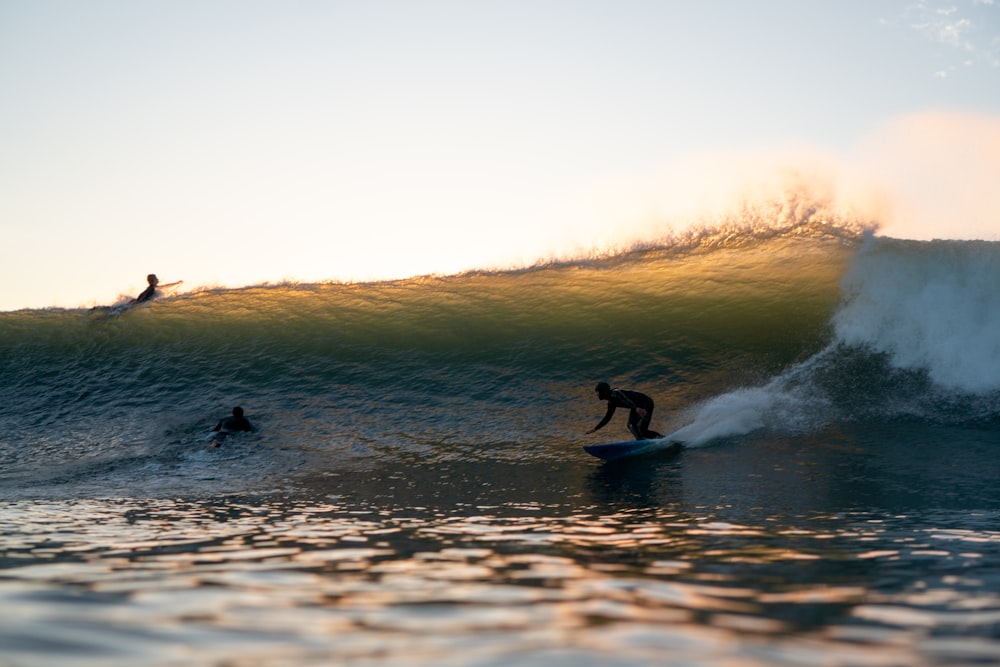 two surfers are riding a wave in the ocean