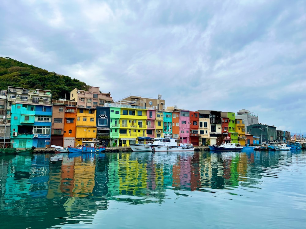 a row of houses on the shore of a body of water