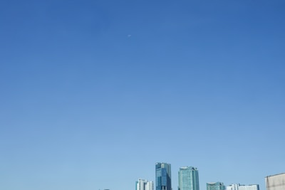 A futuristic city skyline under a royal blue sky, representing innovation in insurance.