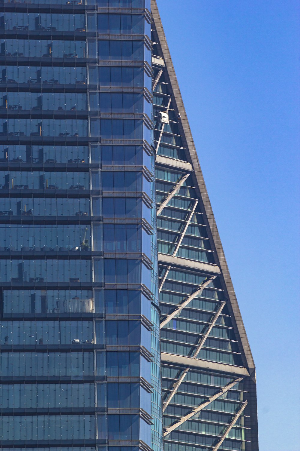 a very tall building with a plane flying in front of it