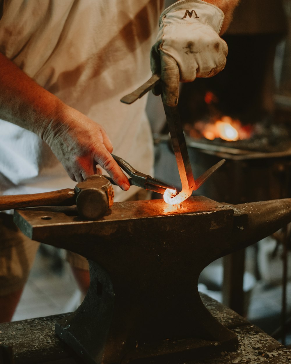 a man is working on a piece of metal