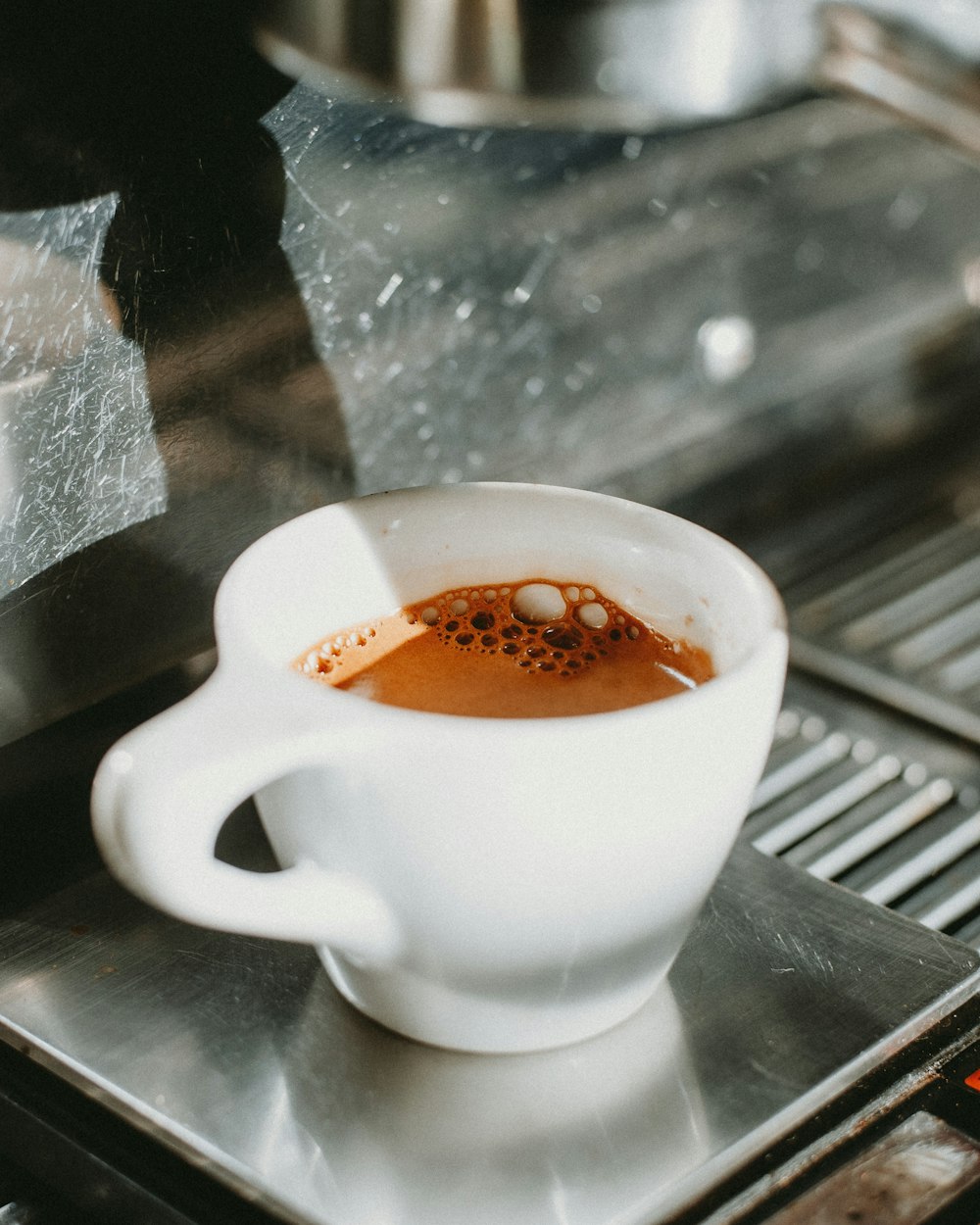 a cup of coffee sitting on top of a stove