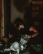 Technician examining machine parts with technical documents in a workshop.