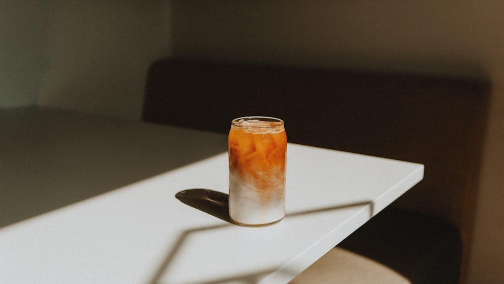 a drink sitting on top of a white table