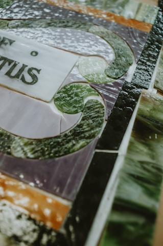 A close-up of a stunning stained glass artwork with golden desert hues, capturing the intricate mosaic patterns with natural light shining through.