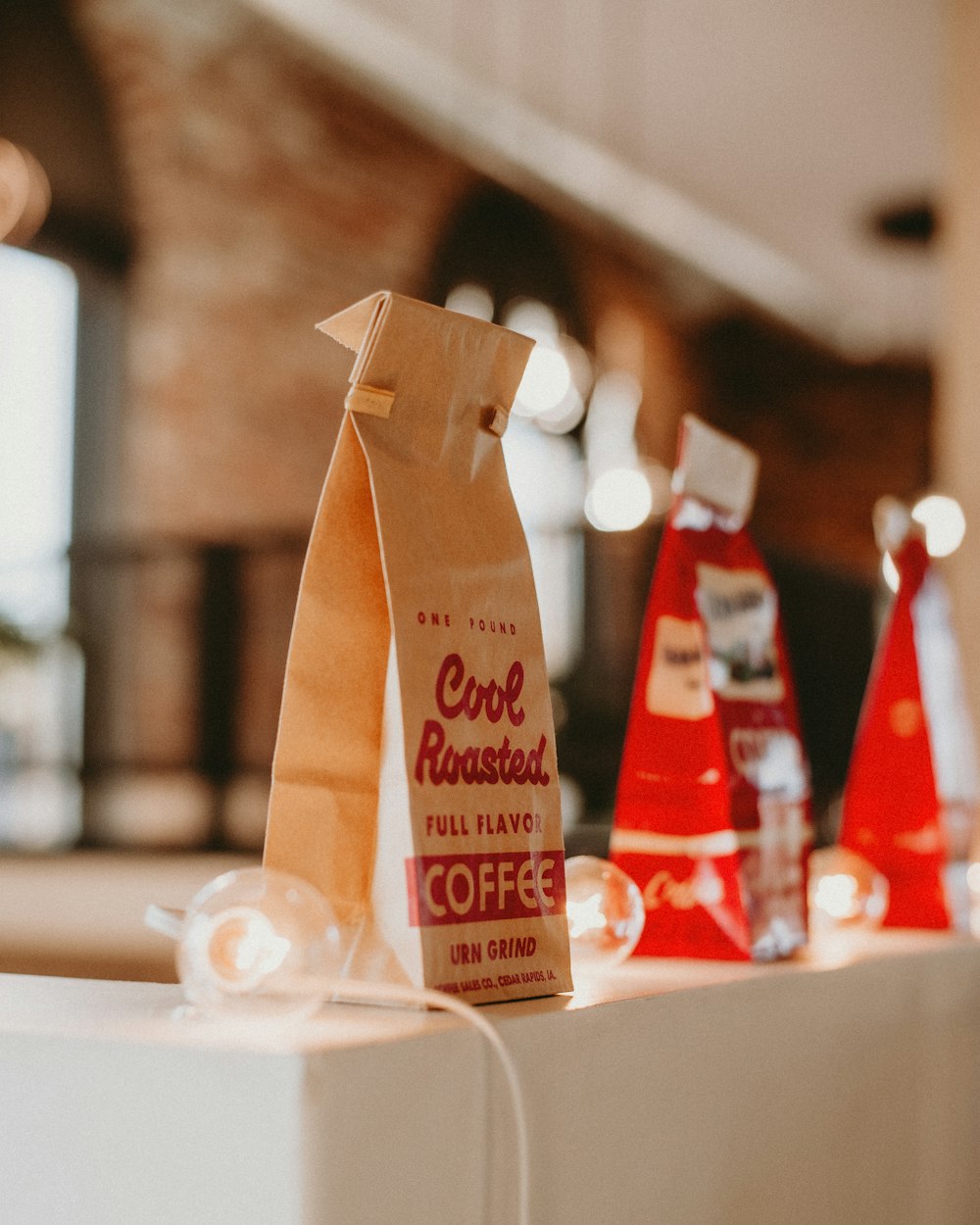 three bags of coffee sitting on top of a table