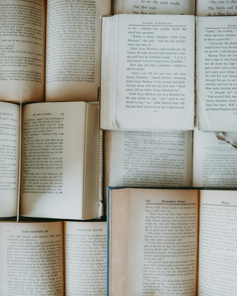 a pile of open books sitting on top of each other