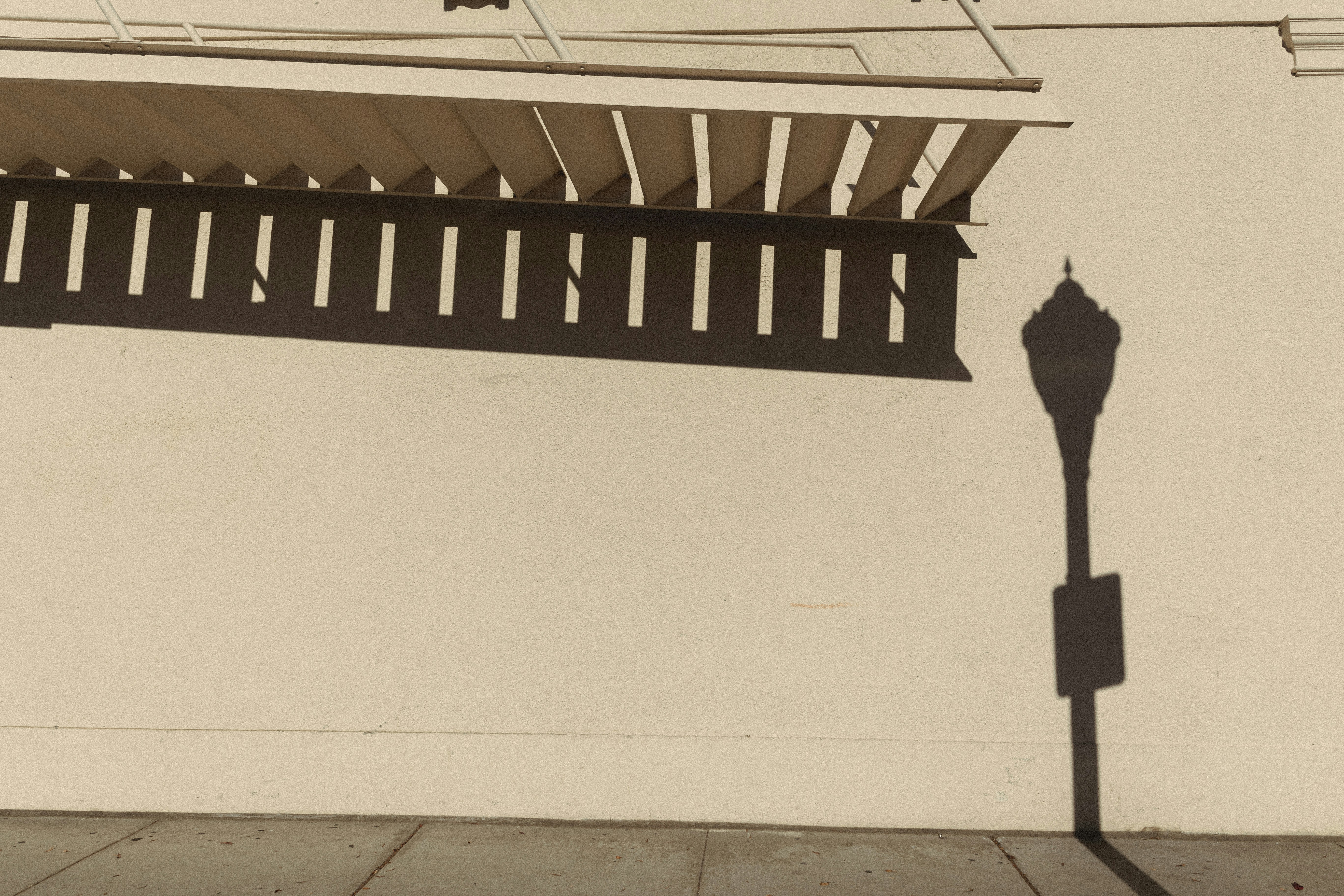 a shadow of a street sign on a wall