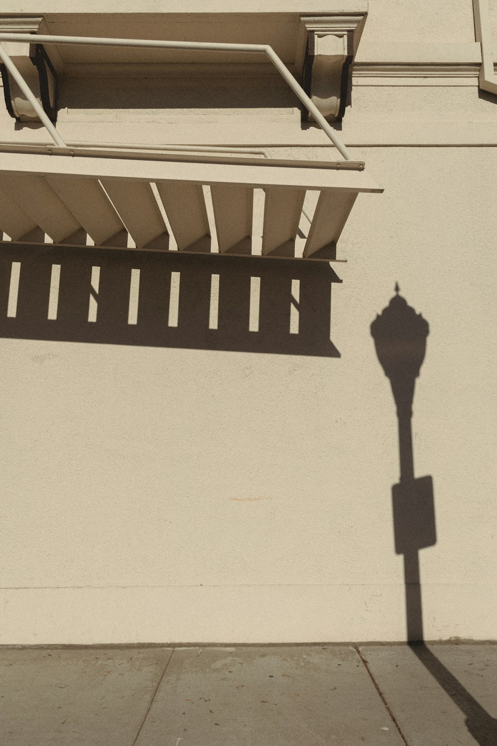 a shadow of a street light on a building