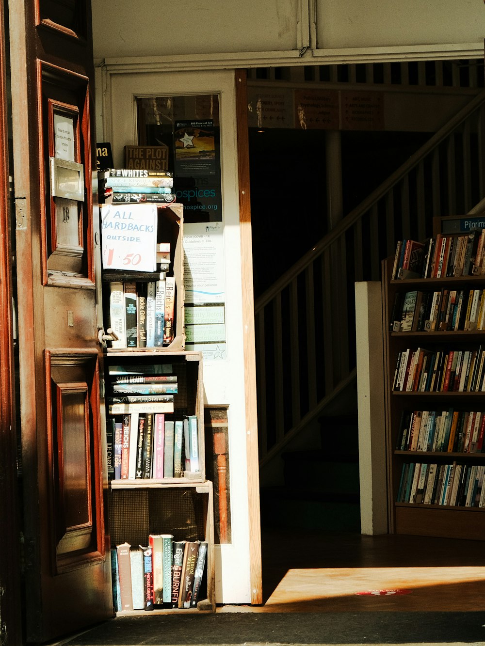 a bookshelf filled with lots of books next to a doorway