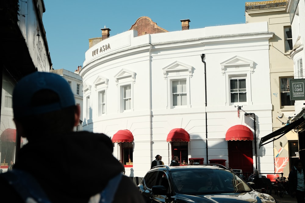 a white building with cars parked in front of it