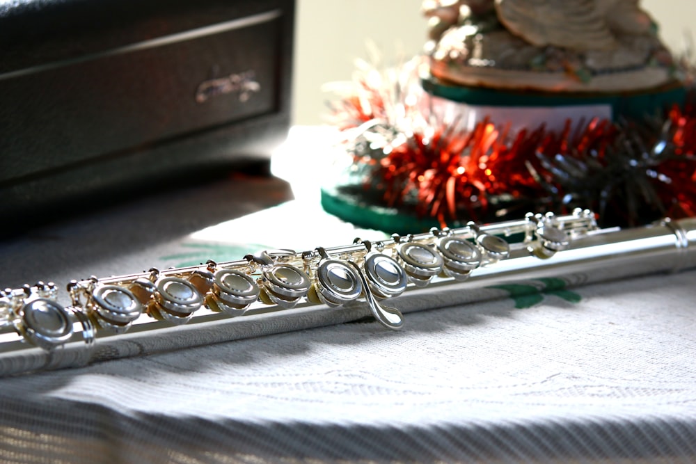 a silver flute sitting on top of a table