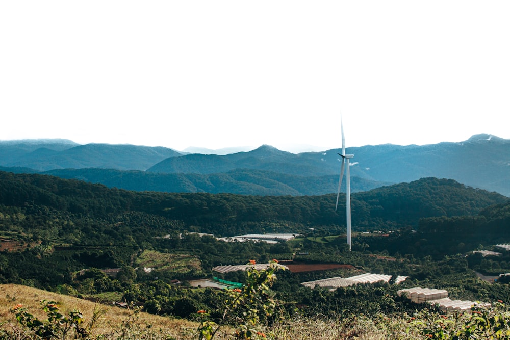 a wind turbine on top of a hill