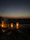 A romantic beachside candlelit dinner at sunset with soft terracotta and blush accents.