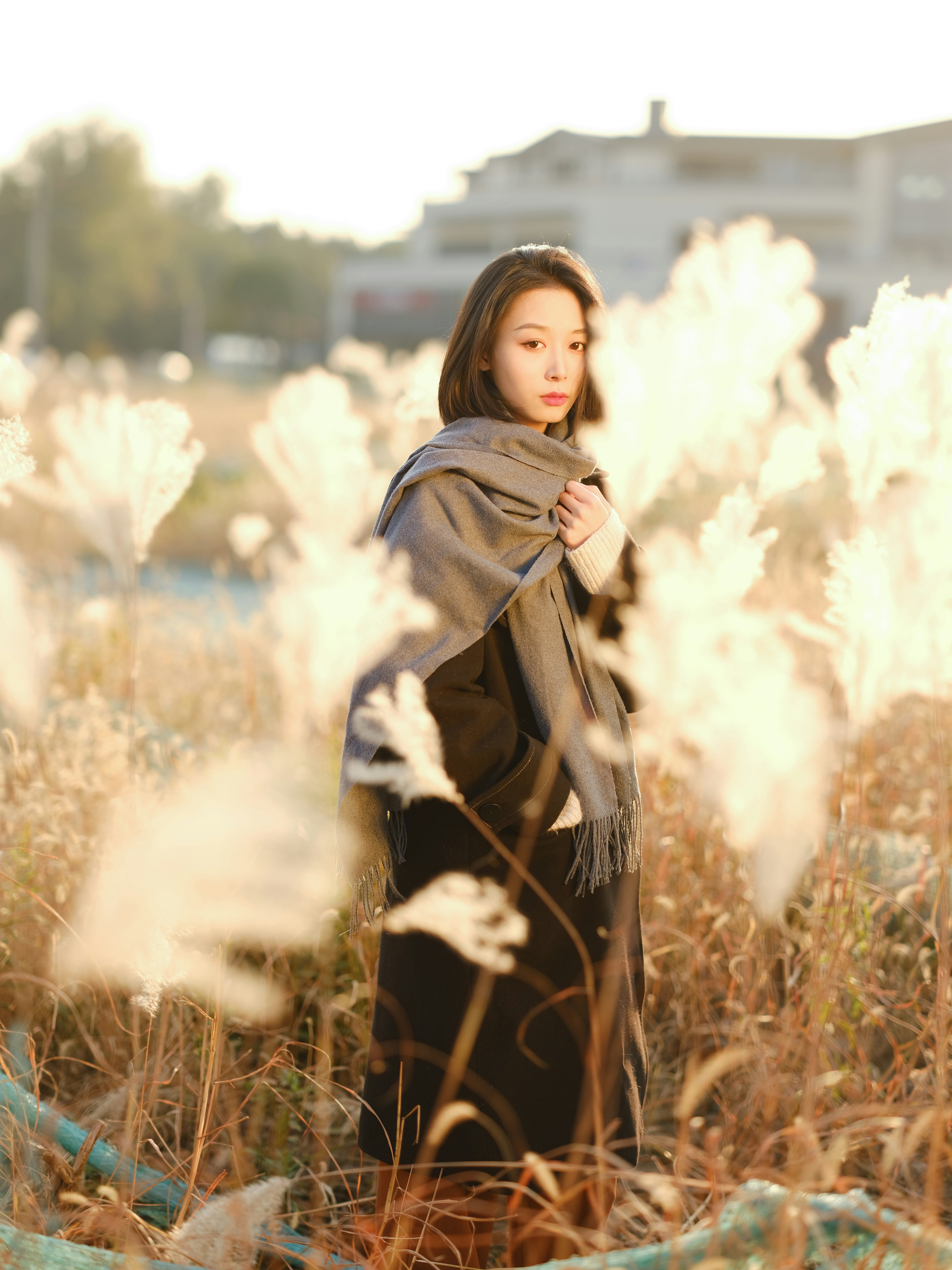 a woman standing in a field of tall grass