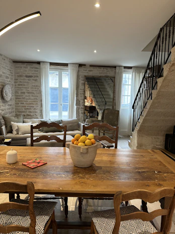 Rustic dining area featuring a linen table runner and coordinating chair cushions.