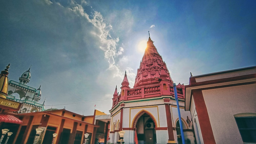 a red and white building with a sky background