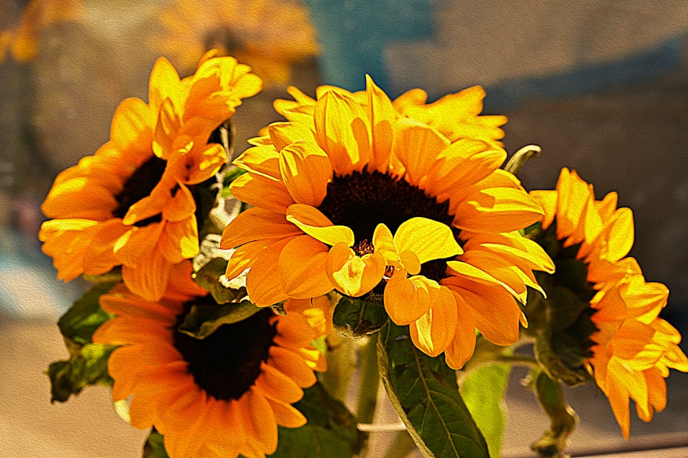 a vase filled with yellow sunflowers sitting on a table