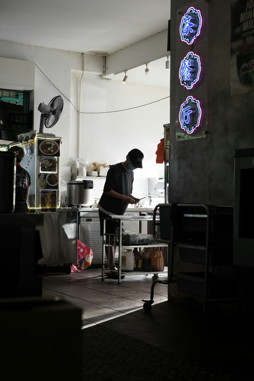 a man standing in a kitchen preparing food