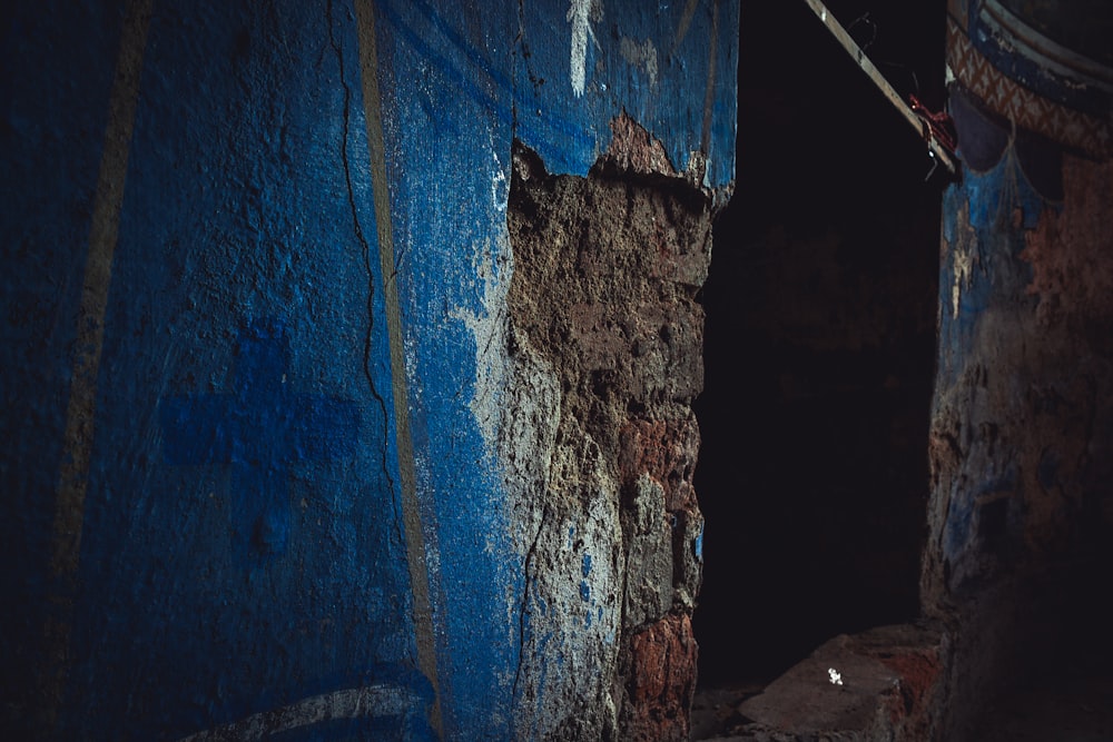 a blue door with a rusted handle on it