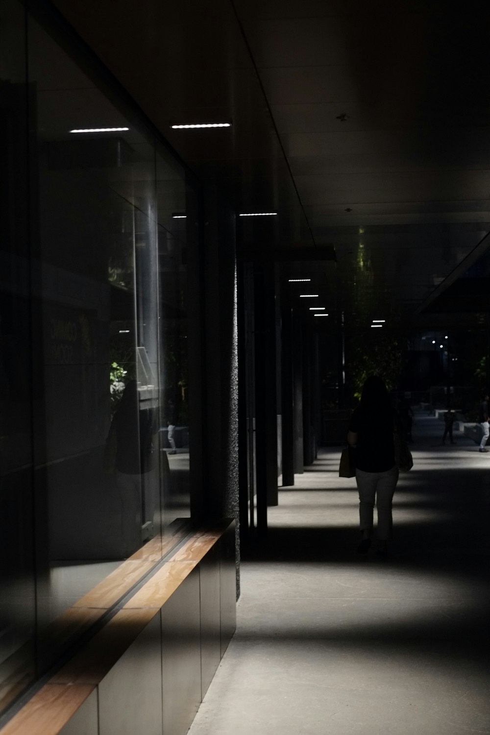 a person walking down a hallway in the dark