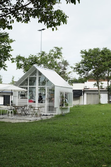 A modern tiny house surrounded by greenery, showcasing innovative architectural design.