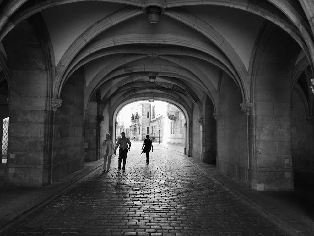 a couple of people that are walking down a street