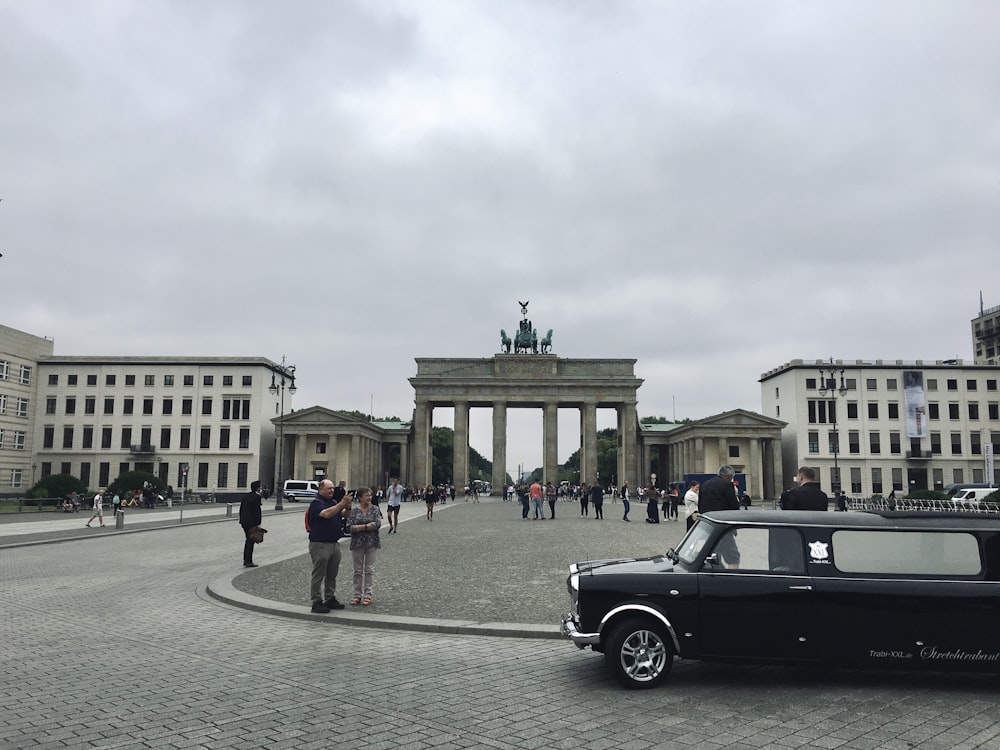 a black car parked in front of a building