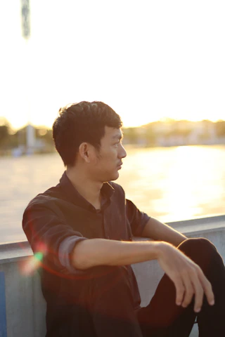 Close-up of B1-Miracle reflecting thoughtfully outdoors with Florida’s sun setting.