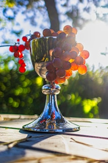 Bunches of glossy grapes displayed on a rustic wooden table.