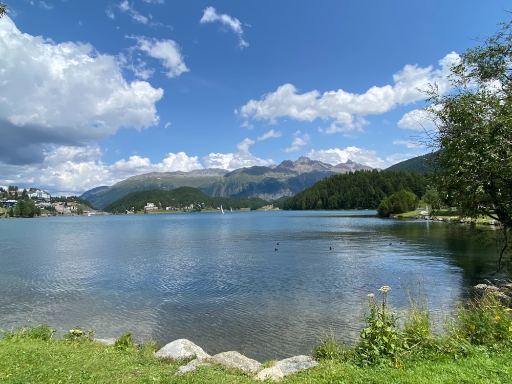 a body of water with mountains in the background