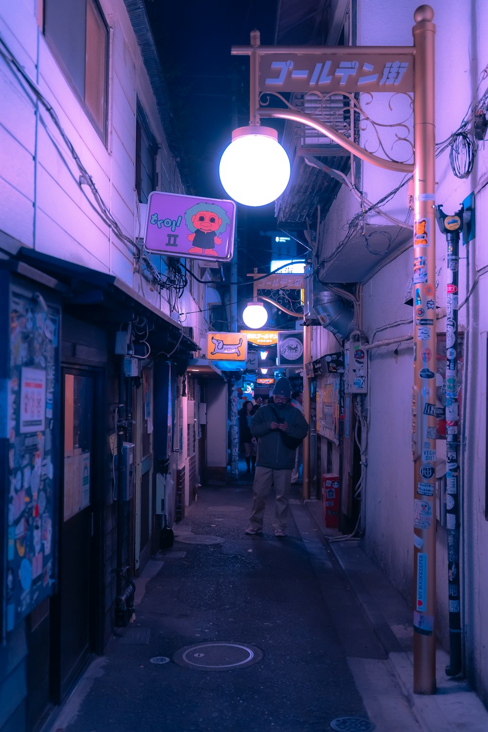 a person walking down a narrow alley way