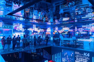 Vibrant restaurant interior with neon accents and lively diners enjoying their meals.