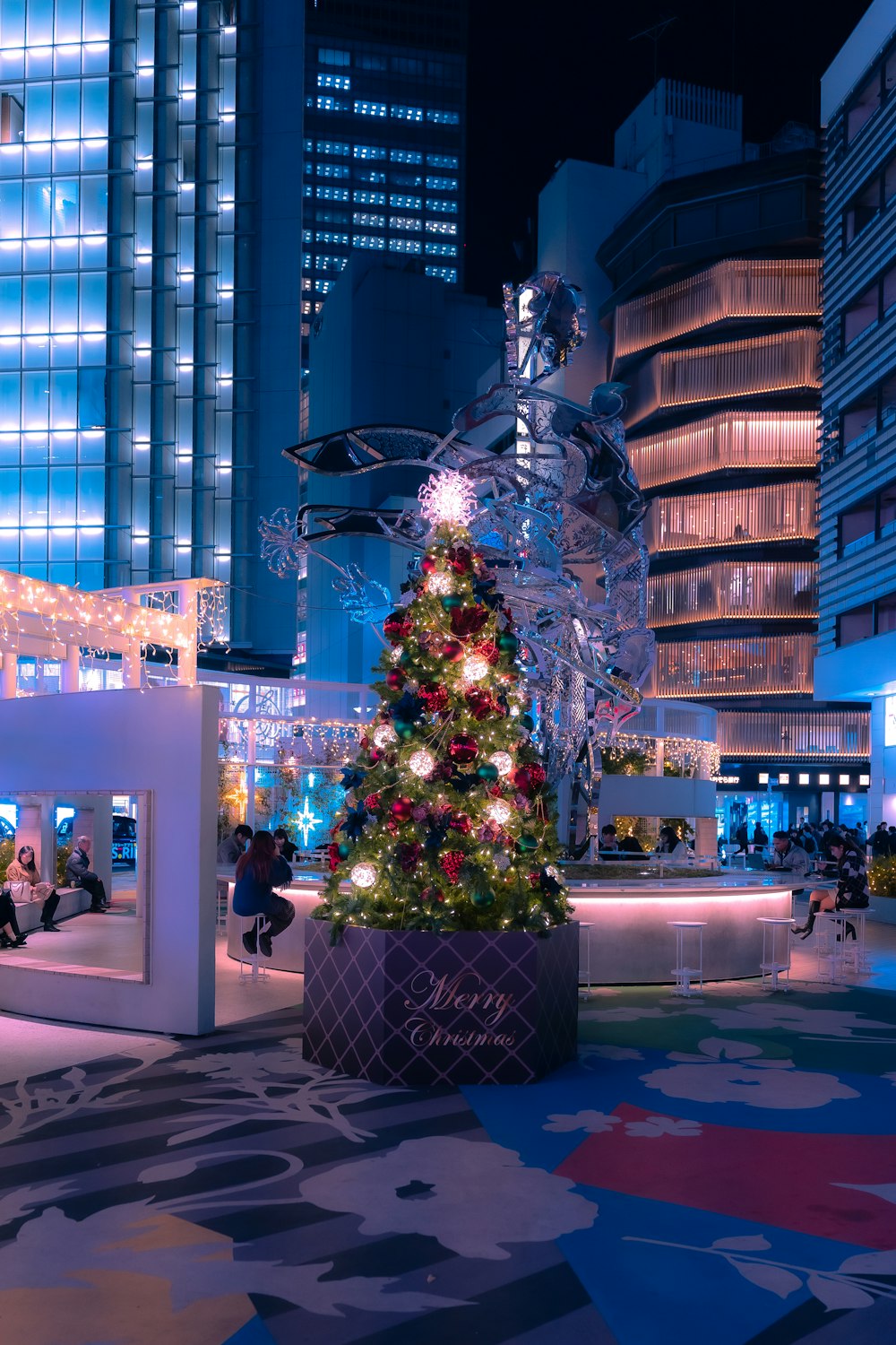 a decorated christmas tree in a city square