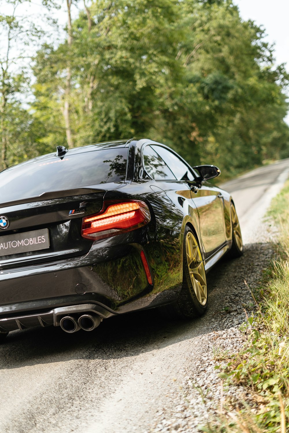 a black sports car parked on the side of a road