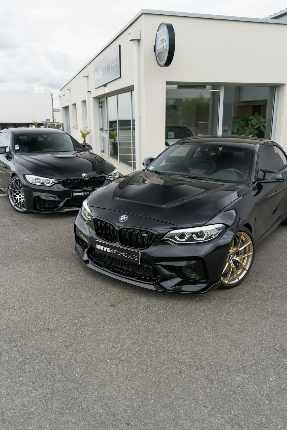 a couple of cars parked in front of a building