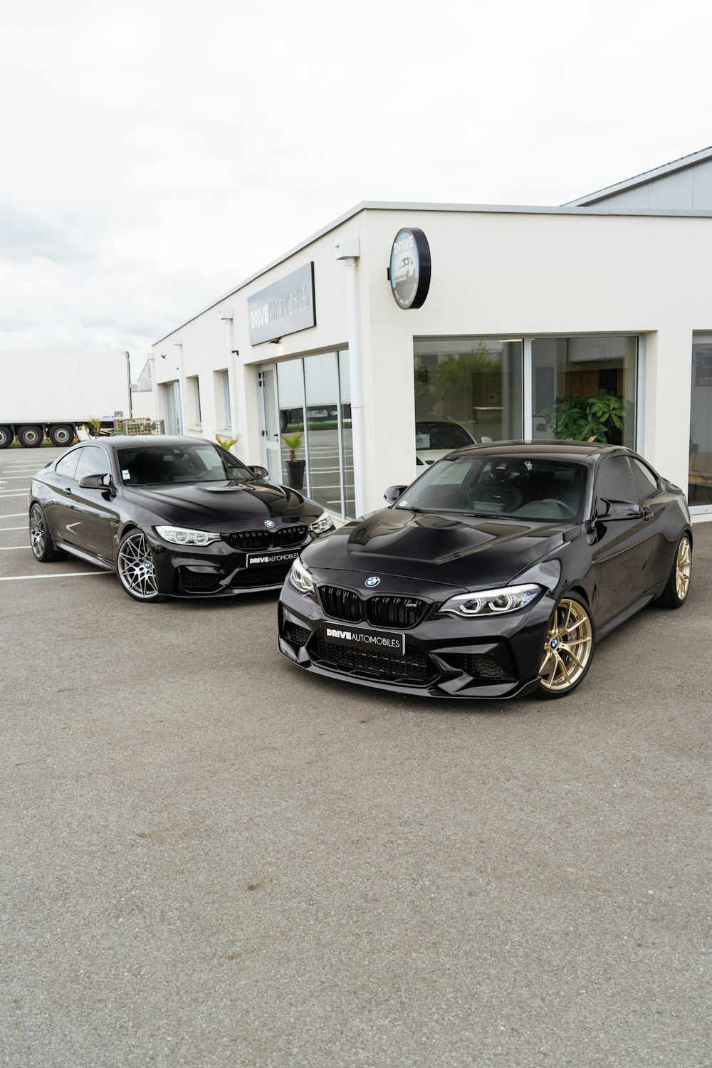 two cars parked in front of a building