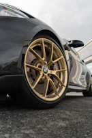 A close-up of a limousine’s polished wheel reflecting the city skyline.