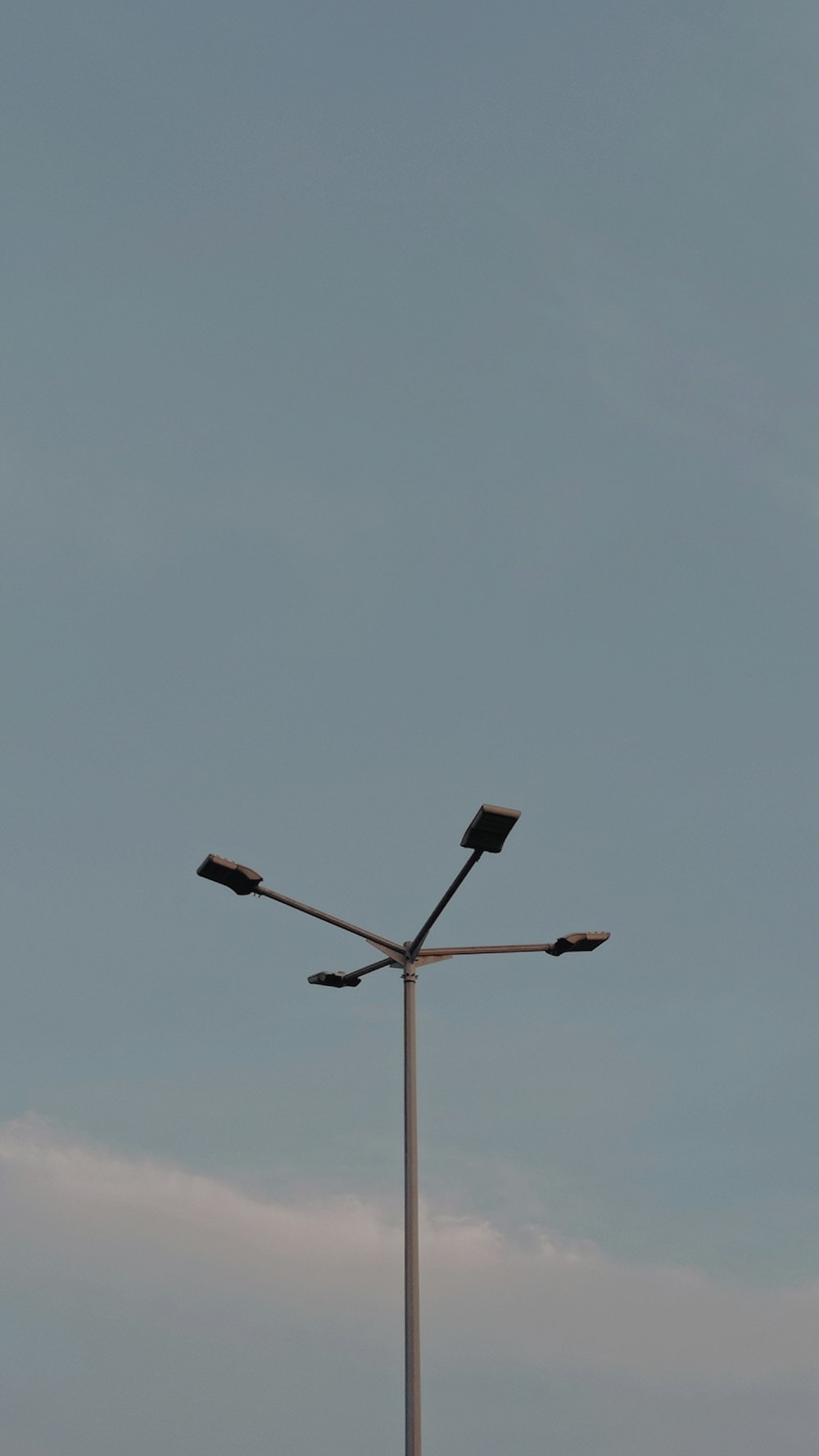 a street light on a pole with a sky background