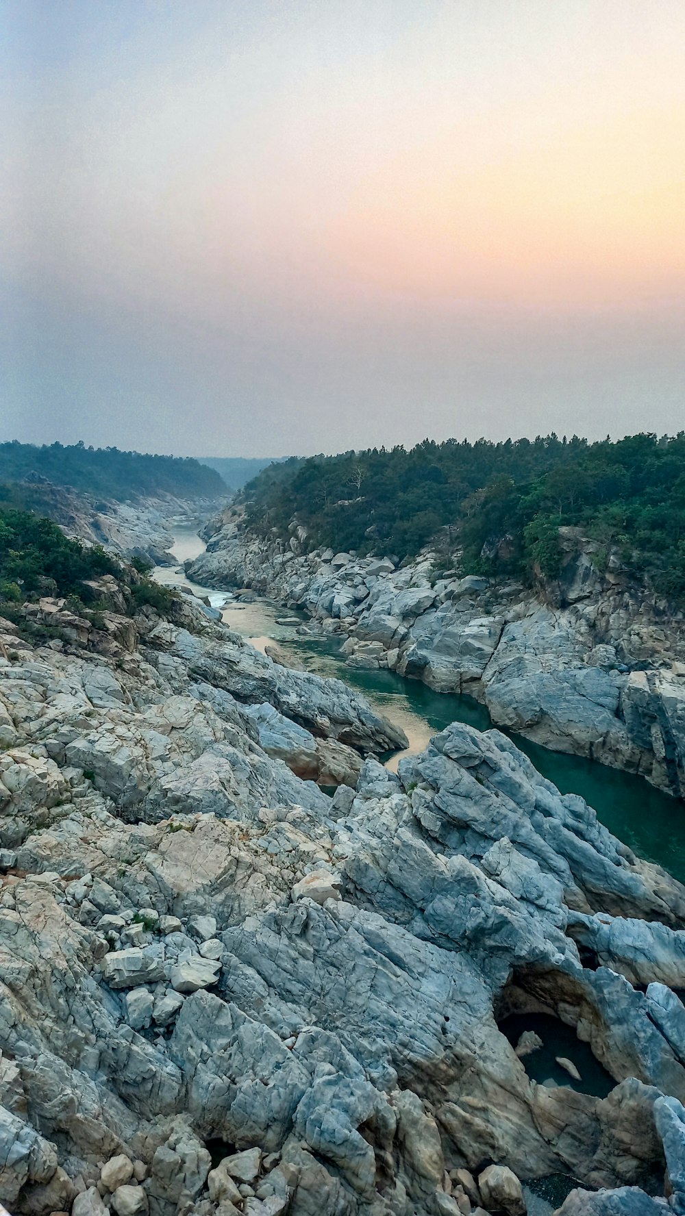 a view of a river running through a rocky area