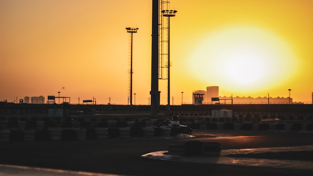 the sun is setting over a race track