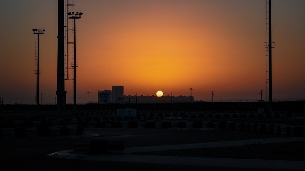 the sun is setting over a city skyline