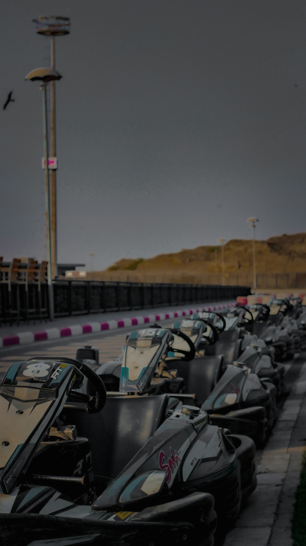 a row of go karts lined up on the side of the road