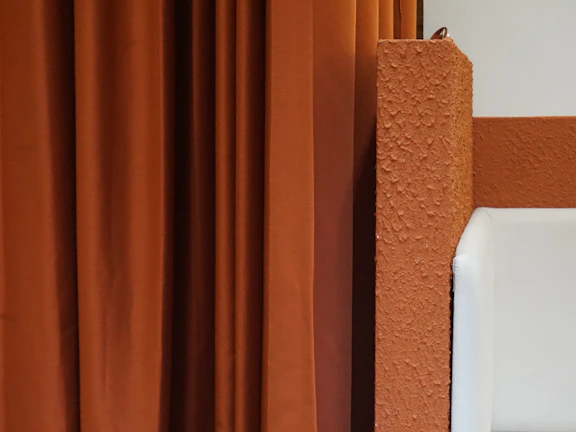 Room makeover featuring a modern living space with fresh bright orange accent walls and clean finishes.