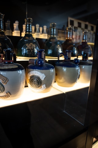 A display of aritsan water bottles lined up, showcasing unique handcrafted designs.