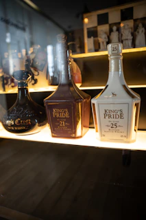 A festive display featuring limited edition whisky bottles, decorated with subtle blue and white accents.