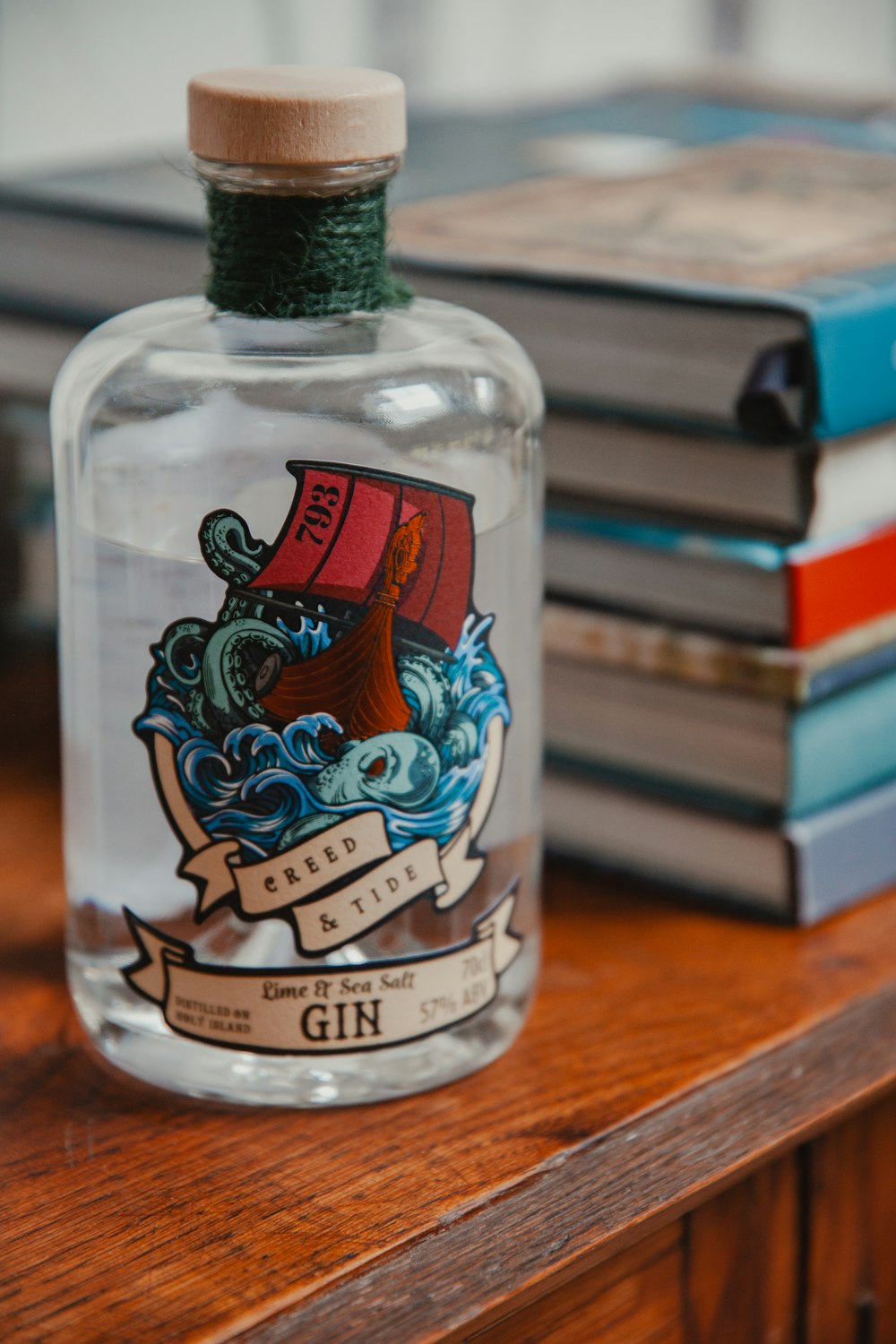 a bottle of gin sitting on top of a wooden table