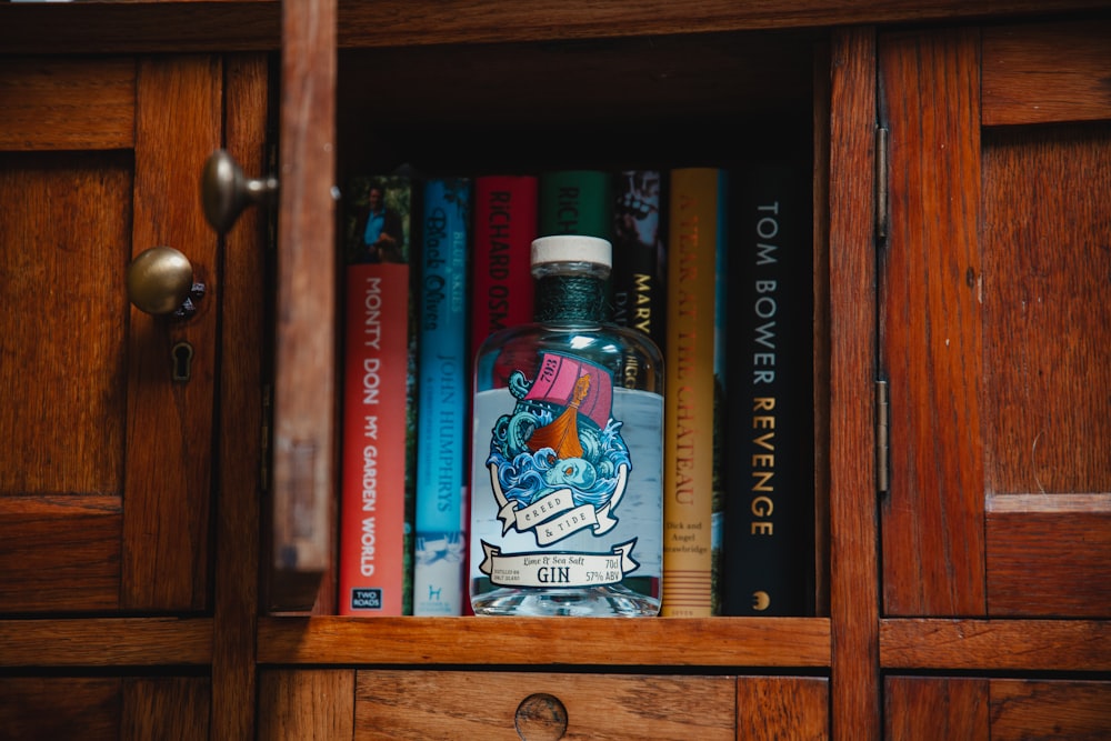 a bottle of liquor sitting on top of a wooden shelf