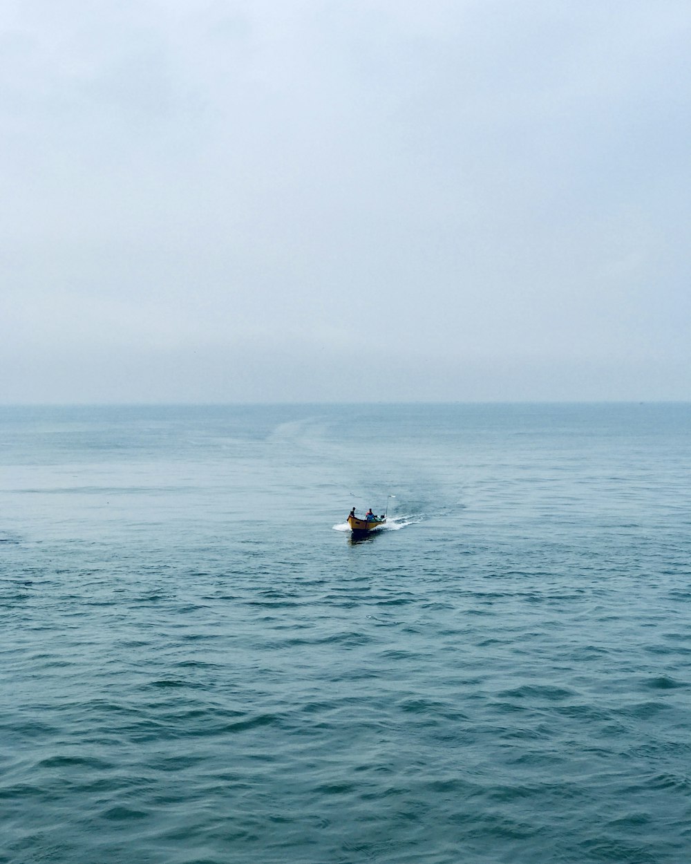 a small boat in a large body of water