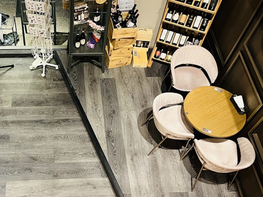 A cozy tasting room with wooden tables displaying a variety of European cheeses and wine glasses.